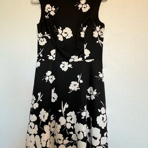 Elegant Black Sleeveless Midi Dress with White Floral Print